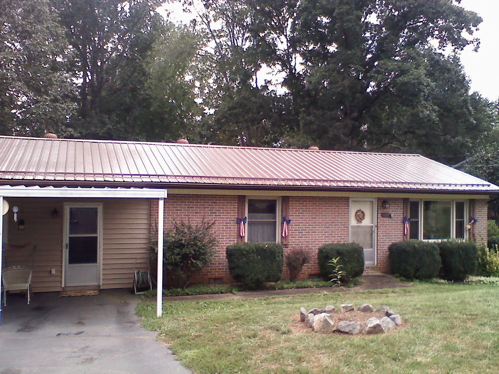 Bronze metal roof and carport on a brick ranch home — Roof Repair work by our crew in Waterman